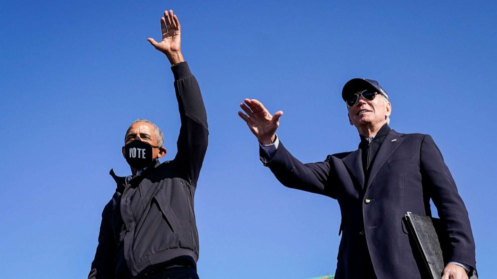 PHOTO: Former President Barack Obama and Democratic presidential nominee Joe Biden wave to the crowd at the end of a drive-in campaign rally at Northwestern High School, Oct. 31, 2020, in Flint, Michigan.