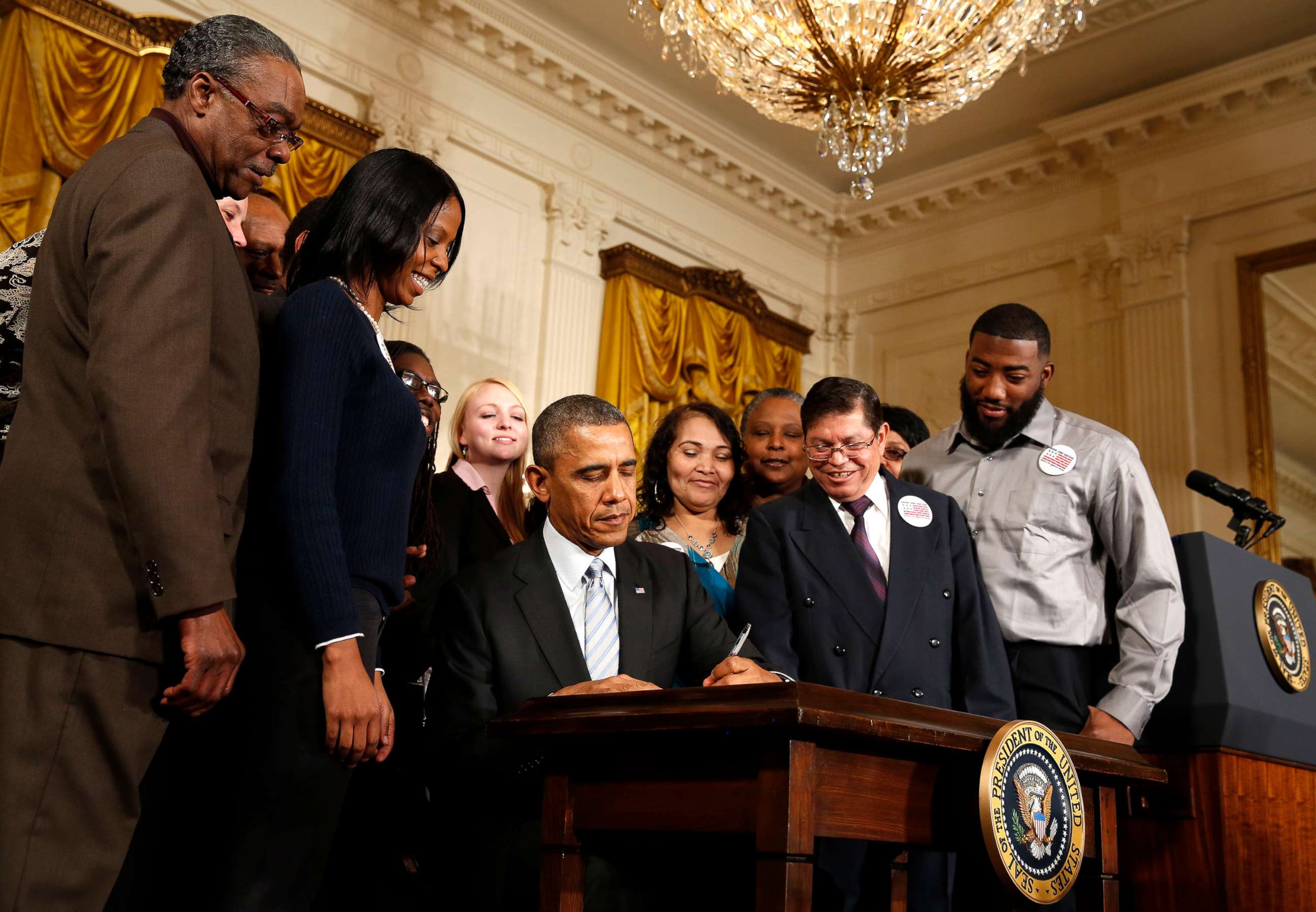 PHOTO: Then-President Barack Obama signs an executive order increasing the minimum wage for employees of federal contractors, in the East Room at the White House in Washington Feb. 12, 2014.