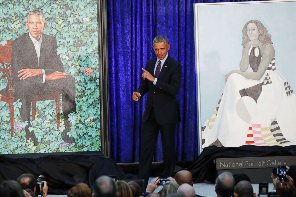 PHOTO: Former U.S. President Barack Obama stands between painted portraits of himself and that of former first lady Michelle Obama during an unveiling ceremony at the Smithsonian's National Portrait Gallery in Washington D.C., Feb. 12, 2018. 