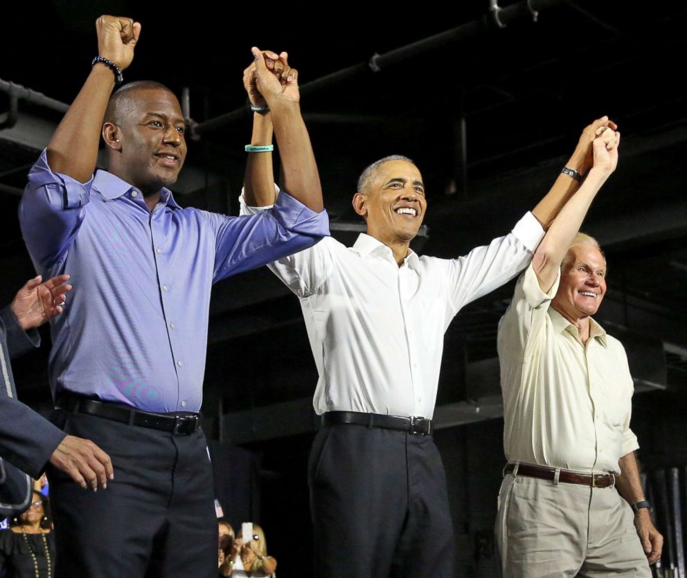 PHOTO: Andrew Gillum, Democratic nominee for governor of Florida, former President Barack Obama and U.S. Senator Bill Nelson join hands during a campaign rally in Miami at Ice Palace Films Studios, Nov. 2, 2018.