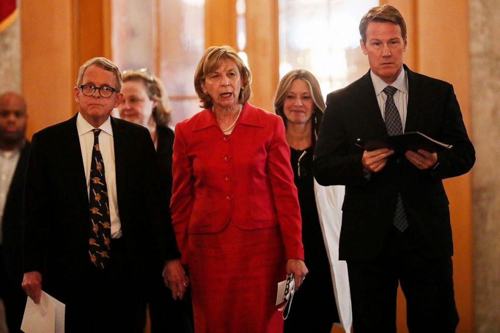 PHOTO: Ohio Gov. Mike DeWine, Fran DeWine, Dr. Amy Acton and Ohio Lt. Gov. Jon Husted walk to the State Room before their daily update regarding the COVID-19 pandemic and the state's response on March 25, 2020, in Columbus, Ohio.