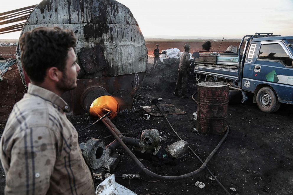 PHOTO: Syrians work at a primitive oil facility, where petrol for cars and heating fuel are being extracted from crude oil purchased from wells controlled by the predominantly Kurdish Syrian Democratic Forces in Ma'arat al-Na'asan, Syria, Oct. 31, 2018.