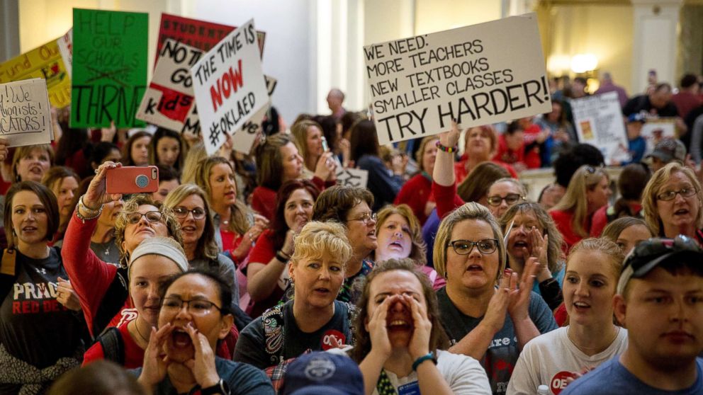 PHOTO: Teachers and demonstrators hold signs during a rally inside the Oklahoma State Capitol building in Oklahoma City, Okla., April 3, 2018.