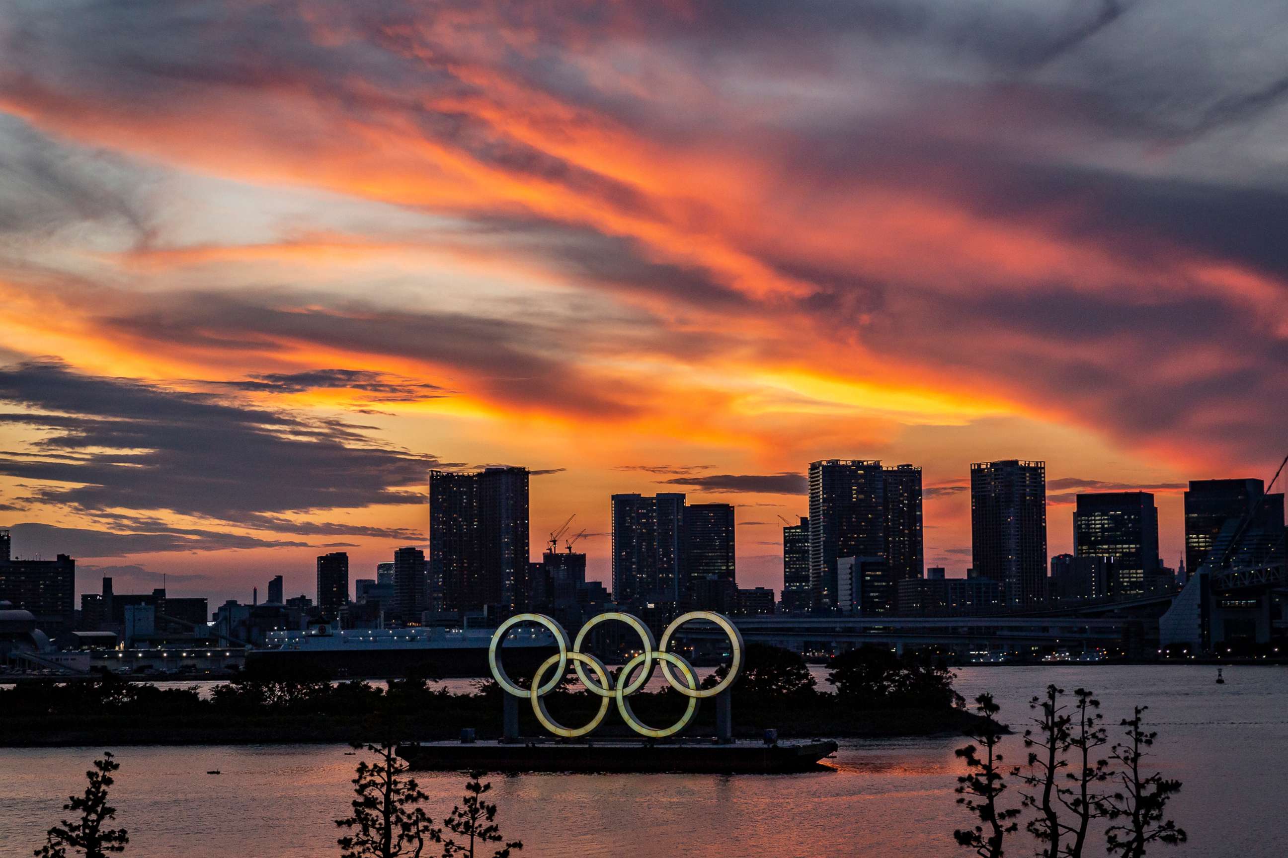 PHOTO: Olympics rings are seen at sunset on July 21, 2021 in Tokyo.