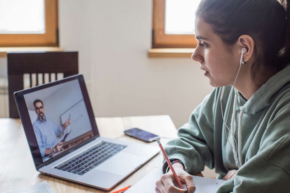 PHOTO: In this undated file photo, a young women at home during the COVID-19 pandemic listens to a lecture online.