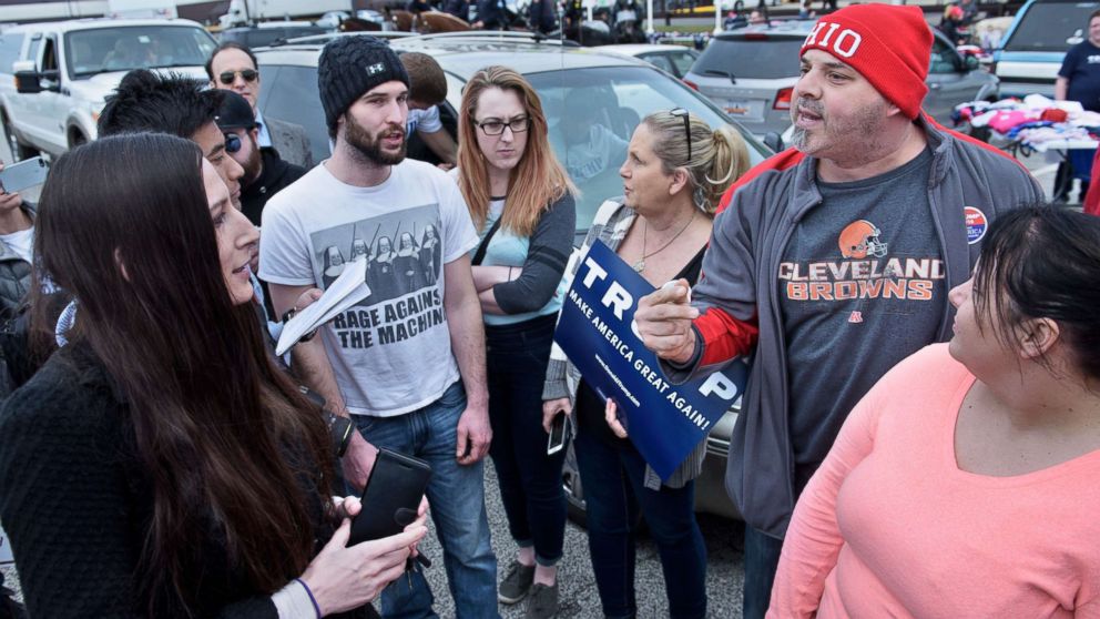 PHOTO: People of opposing political views talk in a parking lot after a Trump rally at the International Exposition Center on March 12, 2016 in Cleveland, Ohio.