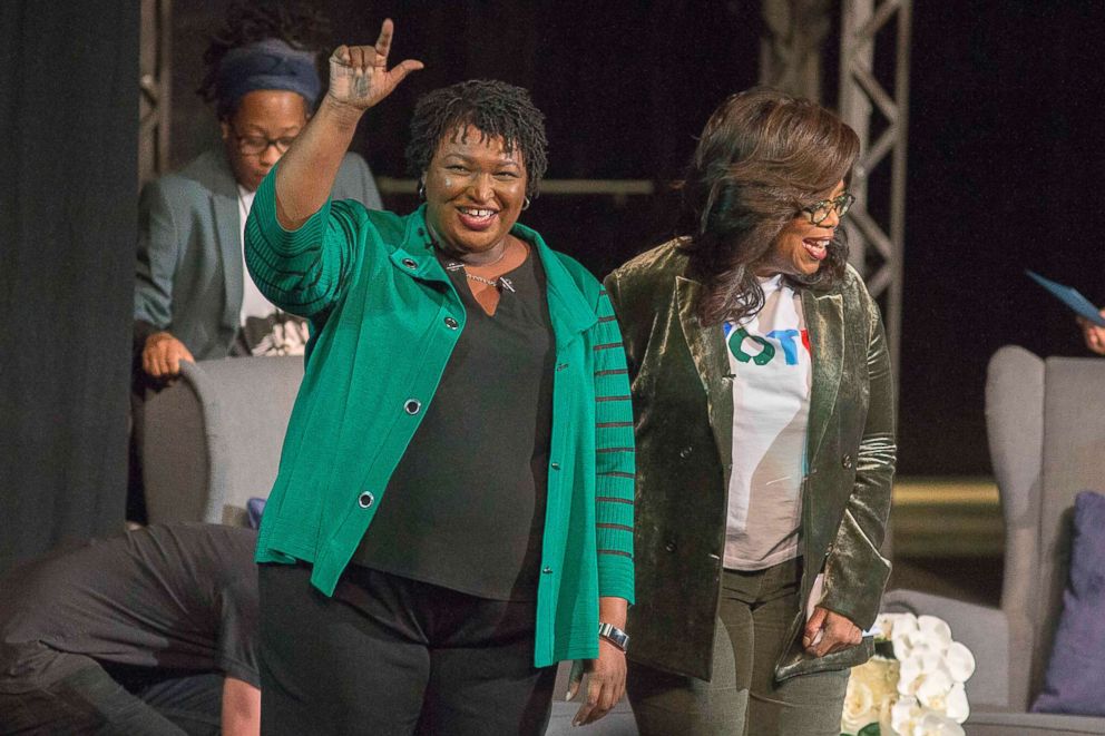 PHOTO: Oprah Winfrey and Georgia gubernatorial candidate Stacey Abrams greet a crowd gathered for a town hall conversation at the Cobb Civic Center's Jennie T. Anderson Theatre in Marietta, Ga., Nov. 1, 2018.