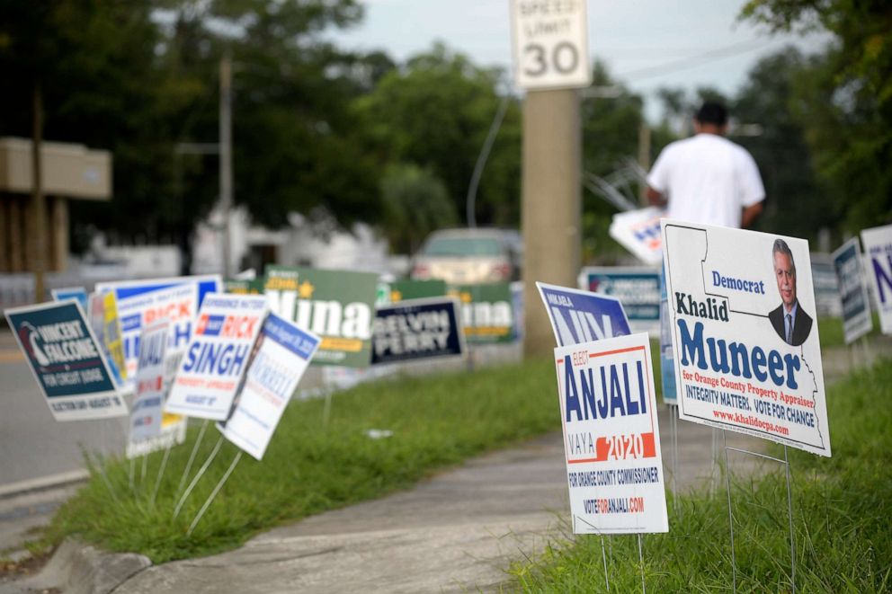 PHOTO: Candidate signs are viewed along a street across from an early voting location at the Supervisor of Elections office, Aug. 13, 2020, in Orlando, Fla.