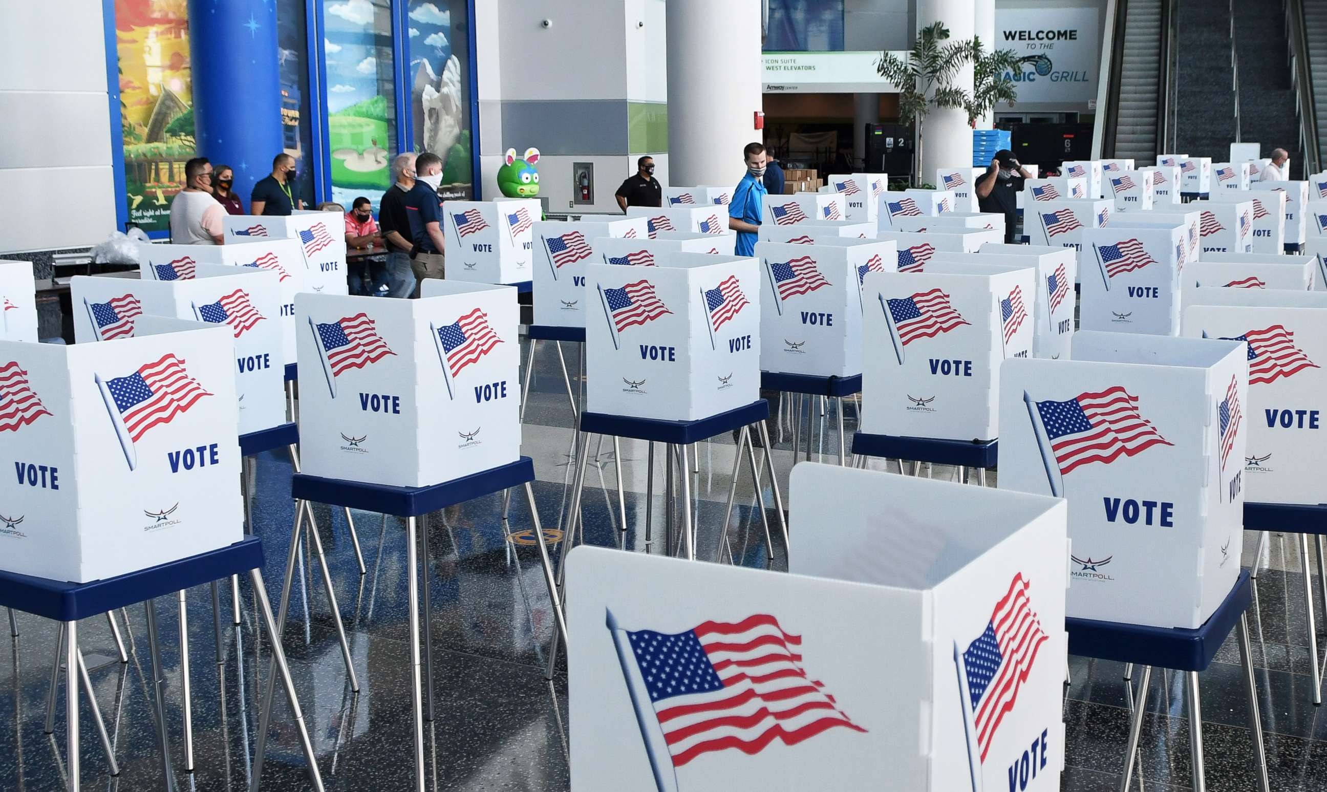 PHOTO: Election workers set up voting booths at an early voting site at the Amway Center, Oct. 15, 2020, in Orlando, Florida.