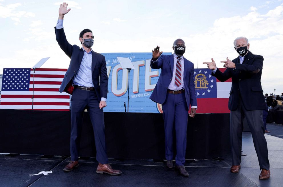 PHOTO: President-elect Joe Biden points to Democratic U.S. Senate candidates from Georgia Jon Ossoff and Raphael Warnock, as he campaigns on their behalf ahead of their Jan. 5 run-off elections, during a drive-in campaign rally in Atlanta, Jan. 4, 2021.