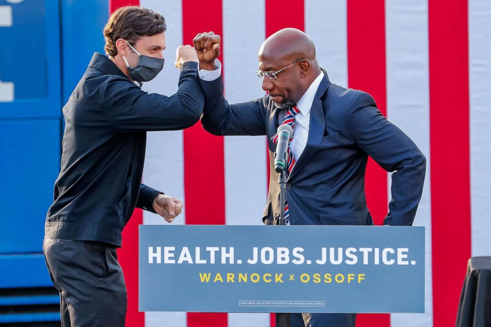 PHOTO: Senate candidates Jon Ossoff and Reverend Raphael Warnock participate in a dual campaign event during the final week of early voting in their US Senate runoff election in Stonecrest, Ga., Dec. 28, 2020.
