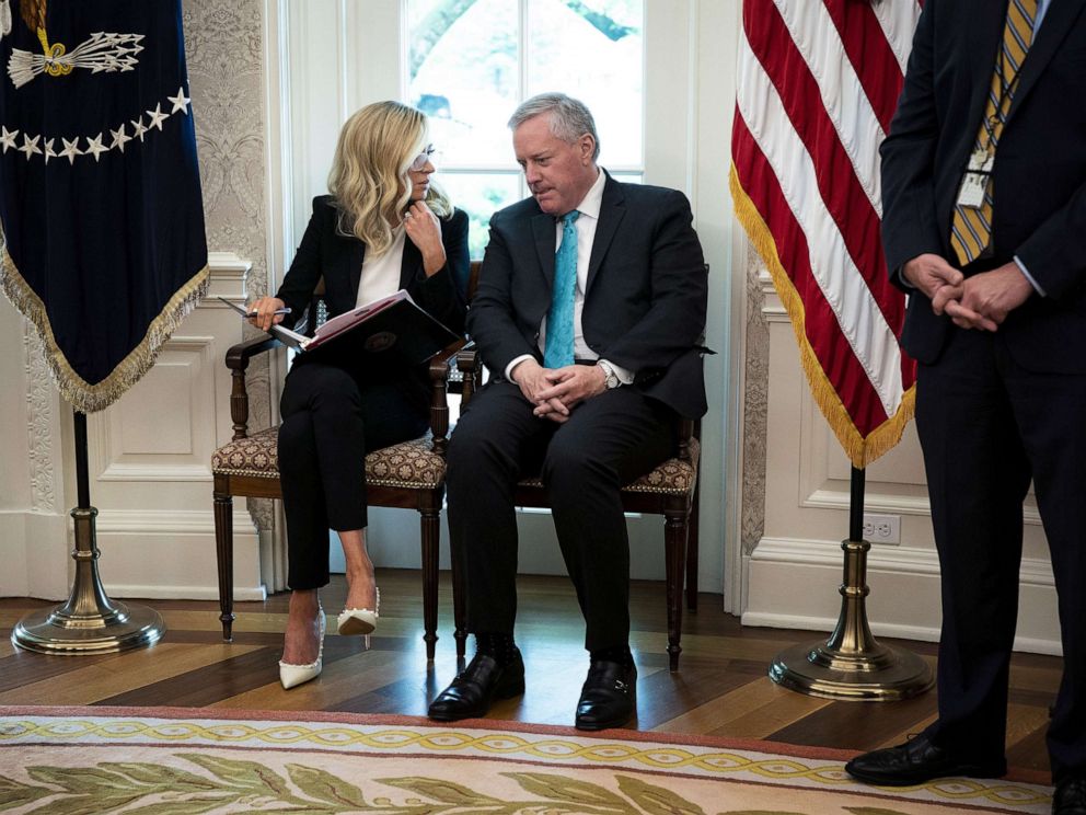 PHOTO: White House Press Secretary Kayleigh McEnany and Chief of Staff Mark Meadows talk in the Oval Office during a meeting with Iowa Governor Kim Reynolds and President Donald Trump, May 6, 2020.