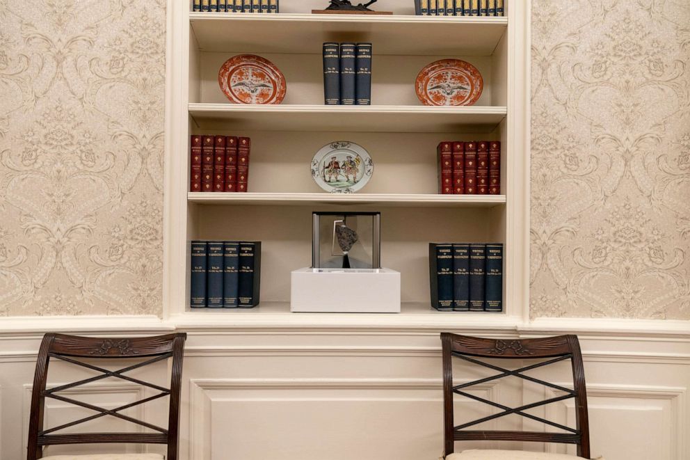 PHOTO: The Oval Office is newly decorated, Jan. 20, 2021, with a rock from the moon on the center shelf.