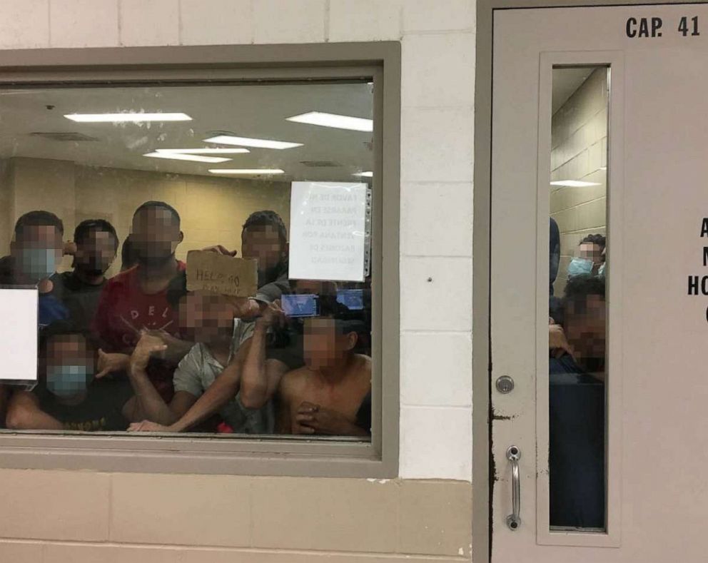 PHOTO: Eighty-eight adult males held in a cell with a maximum capacity of 41, some signaling prolonged detention to OIG Staff, observed by the Office of Inspector General, June 12, 2019, at Border Patrol's Fort Brown Station.