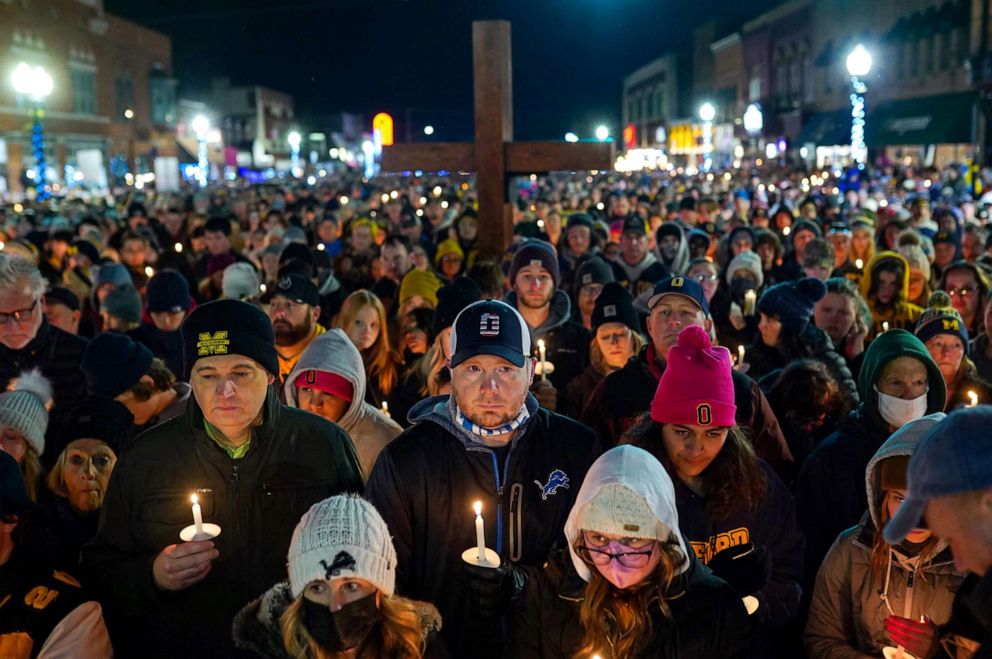 PHOTO: A large group gathers for a vigil in downtown Oxford, Mich., Dec. 3, 2021, after an active shooter situation at Oxford High School left four students dead and others with injuries.