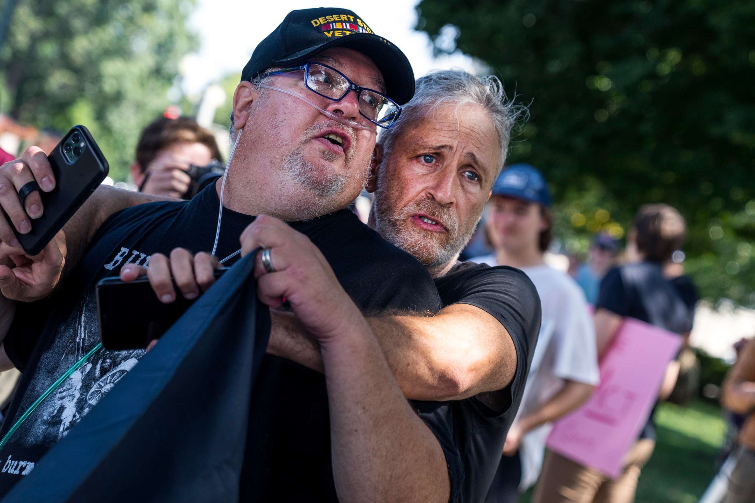 PHOTO: Jon Stewart hugs Tim Hauser, an Air Force veteran, at a rally to call on the Senate to pass the Pact Act, which aims to expand health care and benefits to veterans exposed to toxins while serving, outside the Capitol in Washington, Aug., 2, 2022.