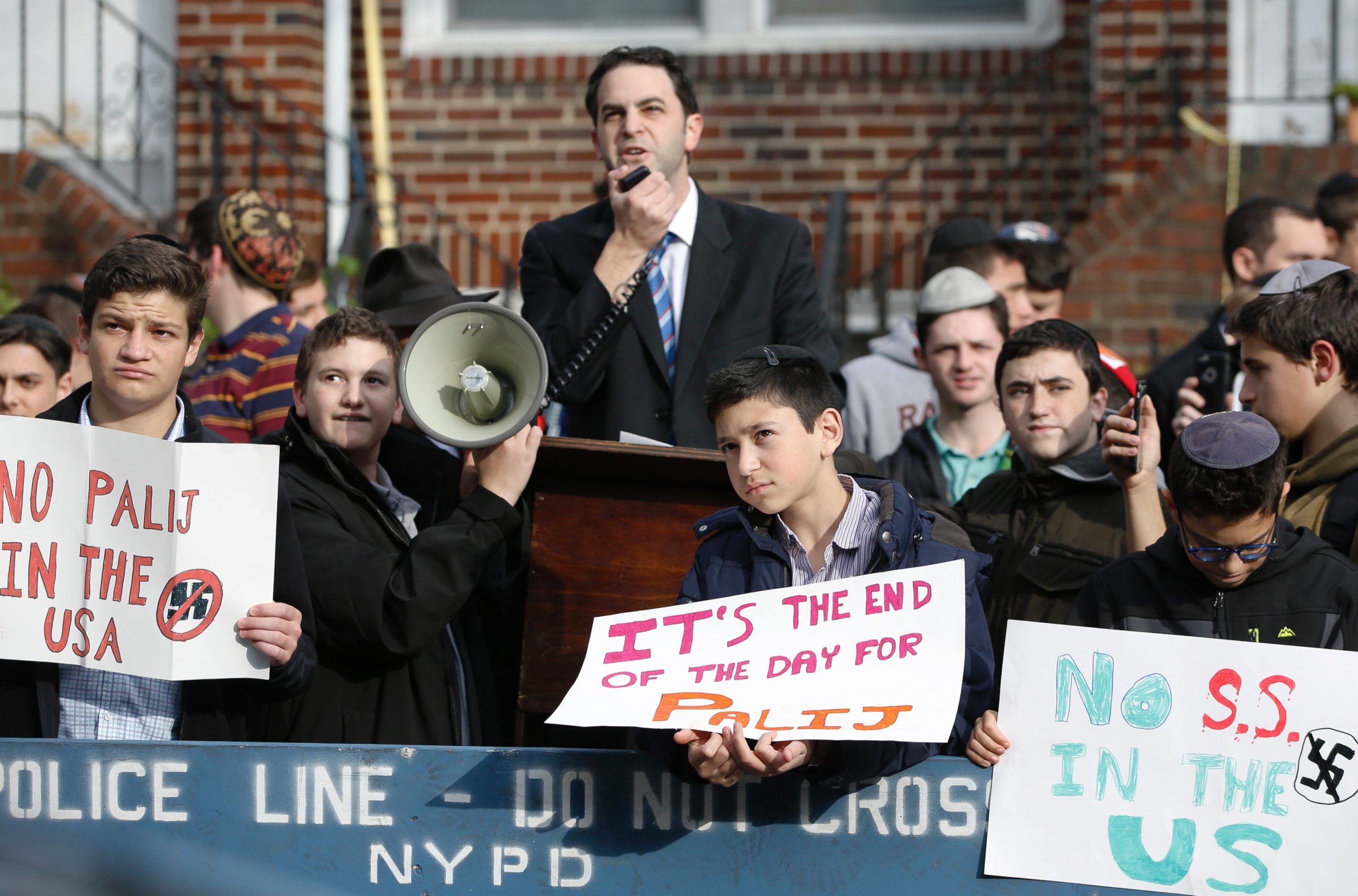Hillel Goldman, associate principal of the Orthodox Jewish Rambam Mesivta High School, speaks as he and students from the school protest former Nazi concentration camp guard Jakiw Palij, 94, Thursday, Nov. 9, 2017, in Jackson Heights, New York. 