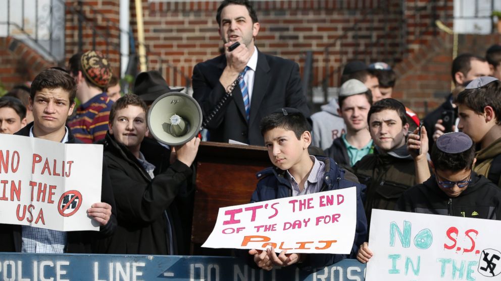 Hillel Goldman, associate principal of the Orthodox Jewish Rambam Mesivta High School, speaks as he and students from the school protest former Nazi concentration camp guard Jakiw Palij, 94, Thursday, Nov. 9, 2017, in Jackson Heights, New York. 