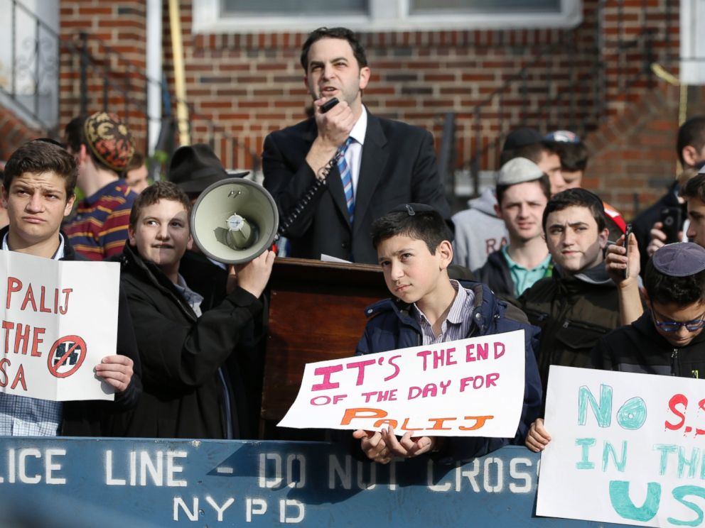 Hillel Goldman, associate principal of the Orthodox Jewish Rambam Mesivta High School, speaks as he and students from the school protest former Nazi concentration camp guard Jakiw Palij, 94, Thursday, Nov. 9, 2017, in Jackson Heights, New York. 