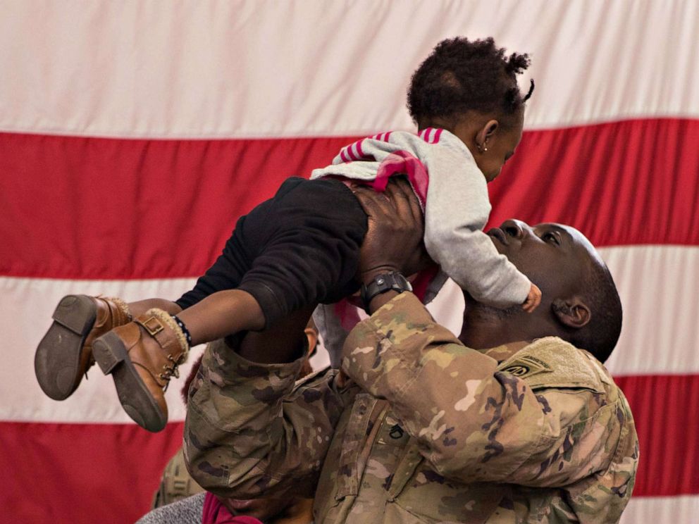 PHOTO: A Paratrooper from 1st Brigade Combat Team, 82nd Airborne Division, holds his daughter during a redeployment ceremony at Fort Bragg, N.C., Feb. 20, 2020.