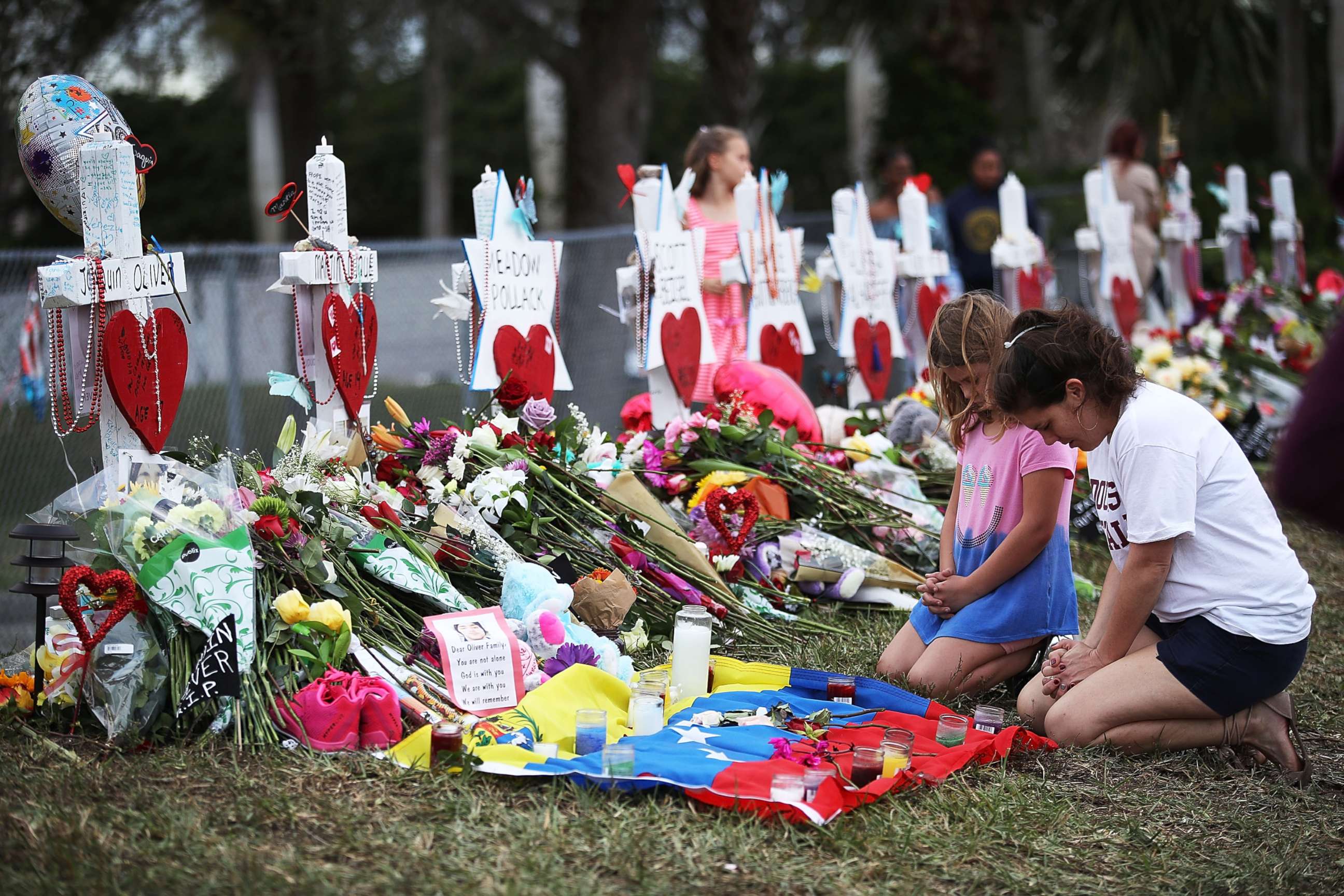 PHOTO: People visit a makeshift memorial setup in front of Marjory Stoneman Douglas High School, Feb. 19, 2018, in Parkland, Florida. 