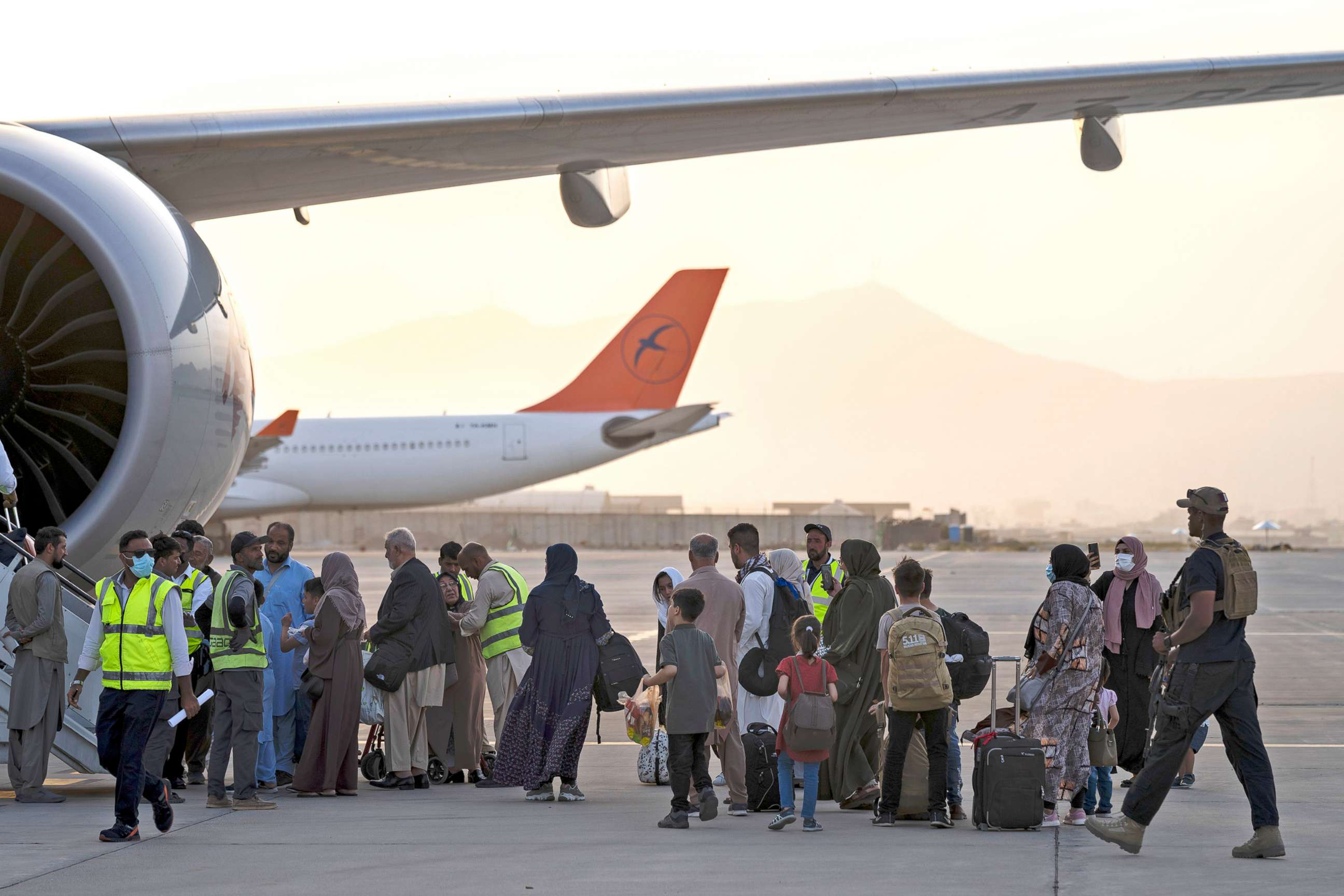 PHOTO: People board a Qatar Airways aircraft at the airport in Kabul, Sept. 9, 2021. Some 200 passengers, including Americans, flew out of Afghanistan on an international commercial flight from Kabul airport on Sept. 9, 2021.