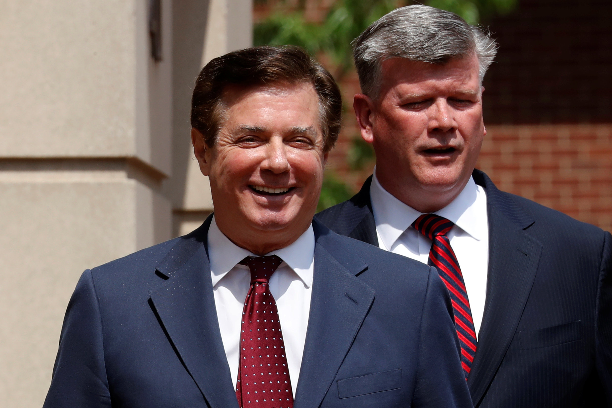 PHOTO: President Trump's former campaign manager Paul Manafort smiles as he and his attorney Kevin Downing depart U.S. District Court after a motions hearing in Alexandria, Va., May 4, 2018.