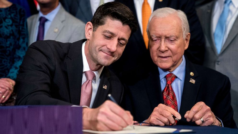 PHOTO: Speaker of the House Paul Ryan accompanied by Senate Finance Committee Chairman Orrin Hatch, right, signs the final version of the GOP tax bill during an enrollment ceremony at the Capitol in Washington, Dec. 21, 2017.