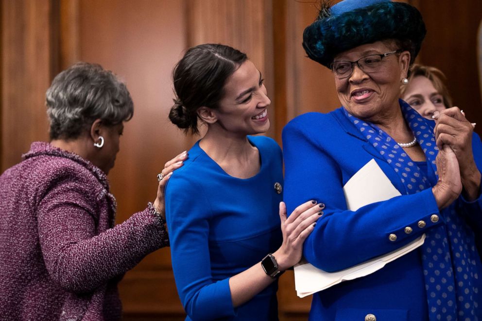 PHOTO: Rep. Brenda Lawrence, left, shows encouragement for Rep. Alexandria Ocasio-Cortez, as she speaks to Rep. Alma Adams at an event to advocate for the Paycheck Fairness Act at the Capitol in Washington, Jan. 30, 2019.