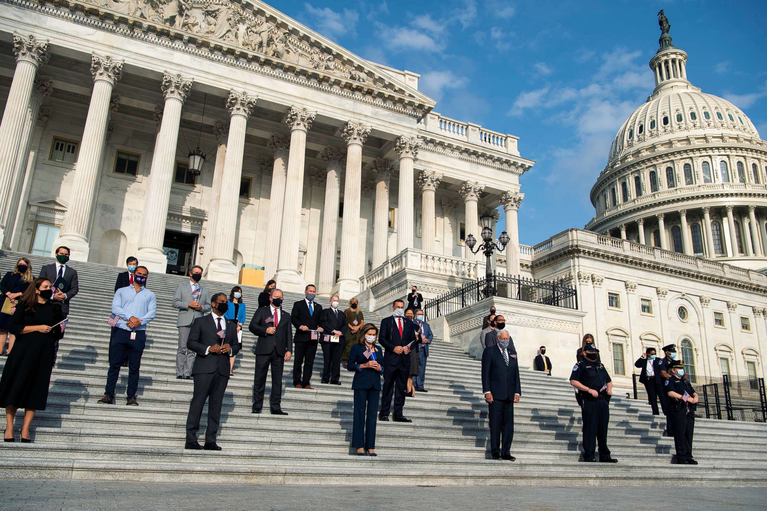 PHOTO: Speaker Nancy Pelosi, along with members and staff, observe a moment of silence on the House steps of the Capitol to honor victims of the September 11, 2001, terrorist attacks on Sept. 11, 2020.