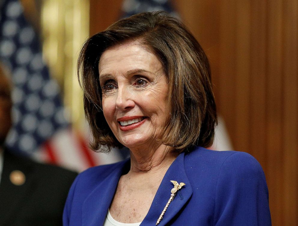 PHOTO: U.S. House Speaker Nancy Pelosi (D-CA) hosts a signing ceremony after the House of Representatives approved a $2.2 trillion coronavirus aid package at the U.S. Capitol in Washington, U.S., March 27, 2020.