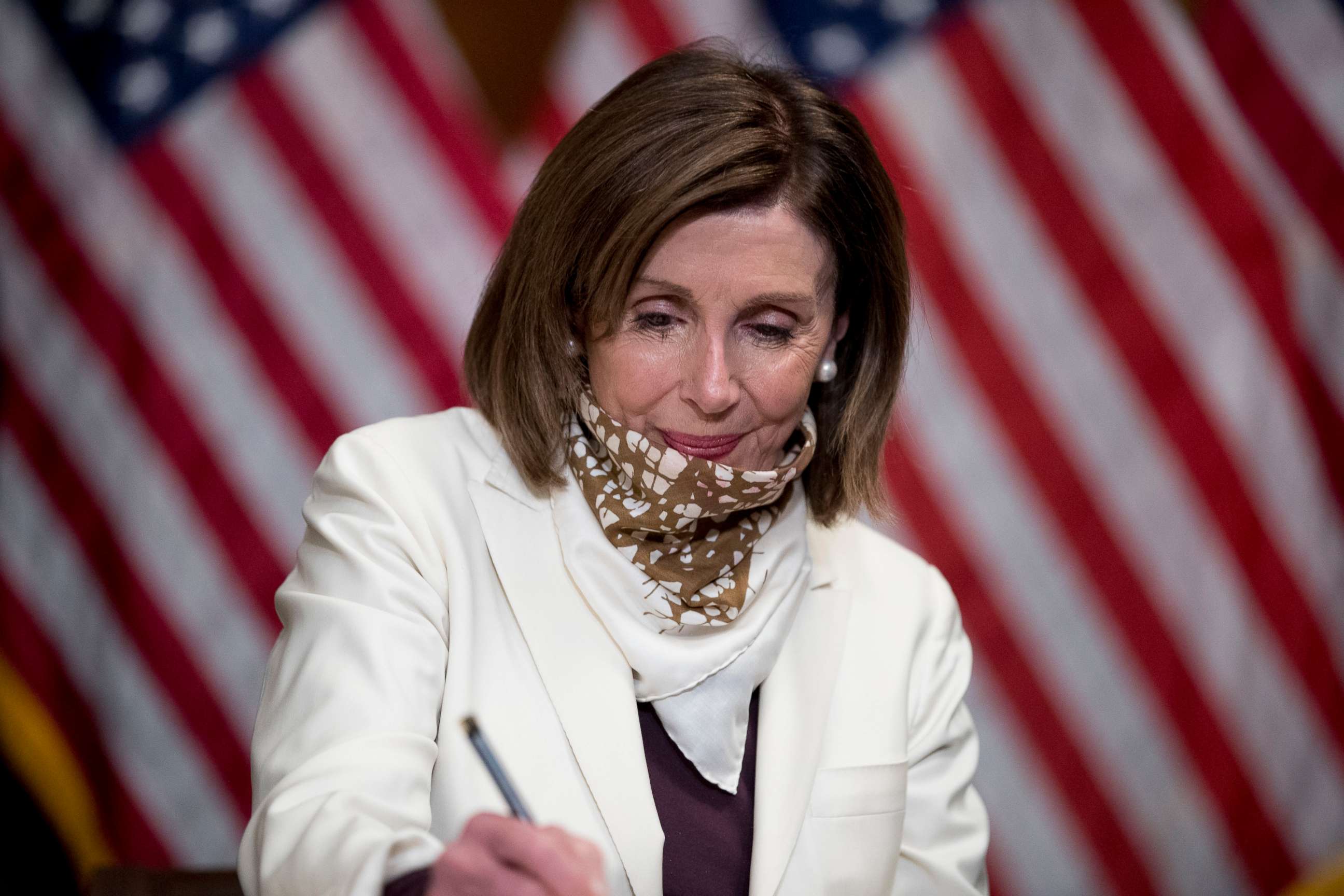 PHOTO: House Speaker Nancy Pelosi of Calif. signs the Paycheck Protection Program and Health Care Enhancement Act after it passed the House on Capitol Hill, April 23, 2020, in Washington. 