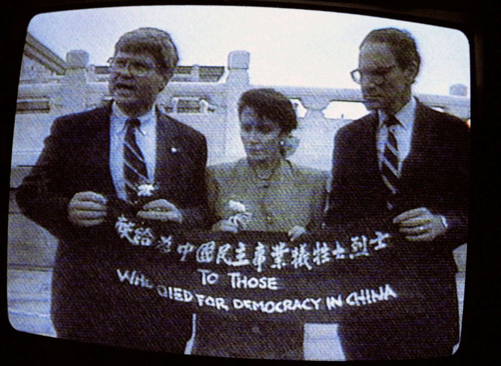 PHOTO: From left, Rep. Ben Jones, Rep. Nancy Pelosi, and Rep. John Miller, hold a banner with the words "To those who died for democracy in China" on Tiananmen Square, Beijing, China, in an image from a TV screen, Sept 4, 1991.