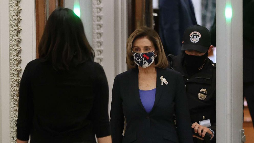 PHOTO: Speaker of the House Nancy Pelosi cooperates with  Capitol Police as she is screened at a metal detector at the doors of the House of Representatives Chamber during a series of votes, Jan. 12, 2021, in Washington, D.C.