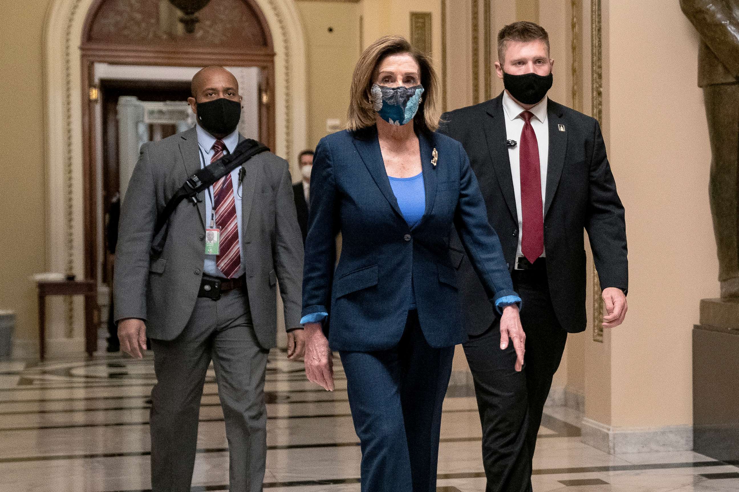PHOTO: Speaker of the House Nancy Pelosi wears a protective mask while walking to her office from the House Floor at the Capitol, Jan. 12, 2021.