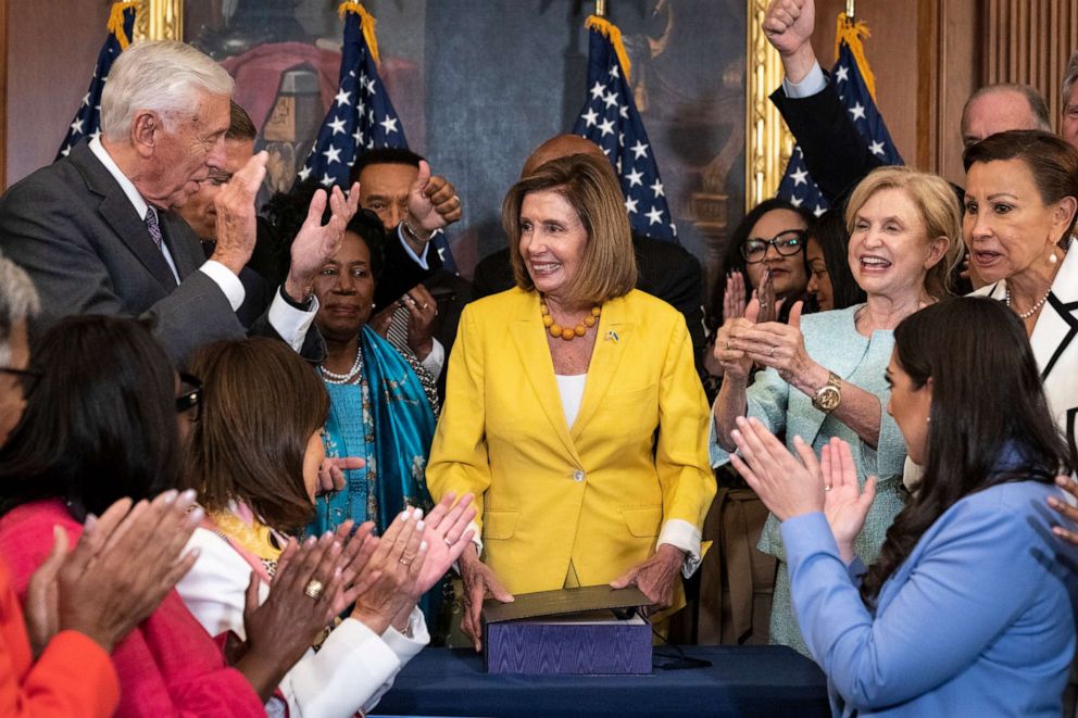 Photo: Democrats applaud after House Speaker Nancy Pelosi signs the inflation-reduction bill into law after the House passed the inflation-reduction bill at the U.S. Capitol on August 12, 2022 in Washington, DC.