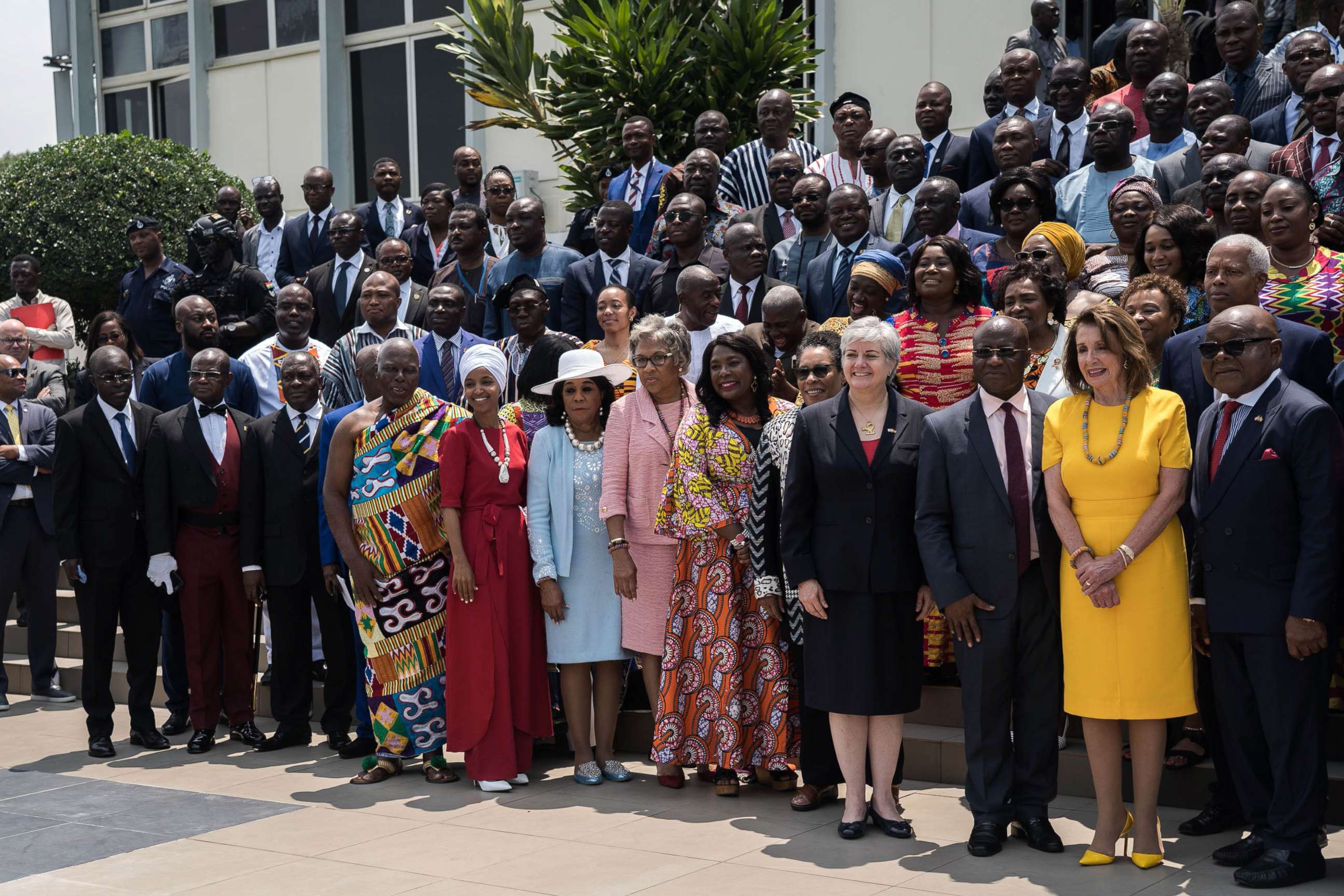 PHOTO: Speaker of the House Nancy Pelosi (2nd R), Speaker of Ghana's Parliament Mike Aaron Oquaye (R) and US Representative Ilhan Omar (5th L) pose for a family picture with members of Parliament in front of the Ghana's Parliament in Accra, July 31, 2019.