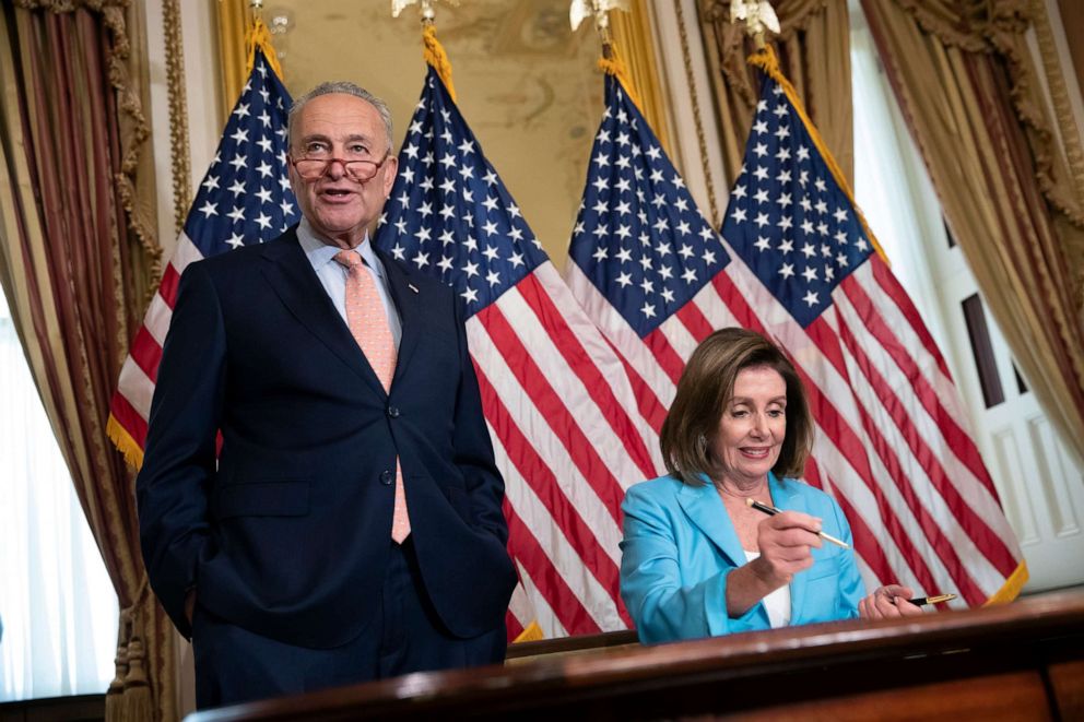 PHOTO: Senate Minority Leader Chuck Schumer joins Speaker of the House Nancy Pelosi as she signs the budget package at the Capitol in Washington, Aug. 1, 2019.