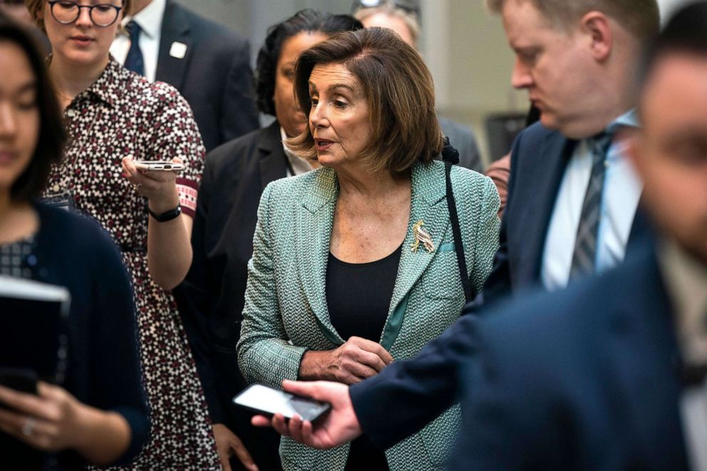 PHOTO: Democratic Speaker of the House Nancy Pelosi speaks to the media as she walks to a caucus meeting in the Capitol in Washington, March 10, 2020. 