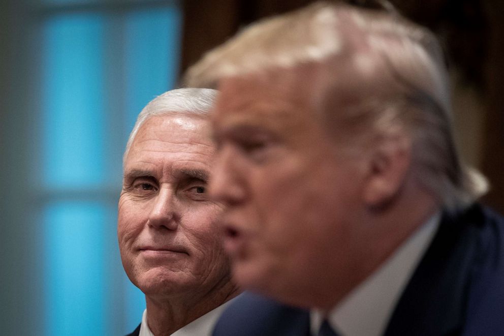 PHOTO: Vice President Mike Pence looks on President Donald Trump speaks during a meeting about the Governors Initiative on Regulatory Innovation in the Cabinet Room of the White House, Dec. 16, 2019.