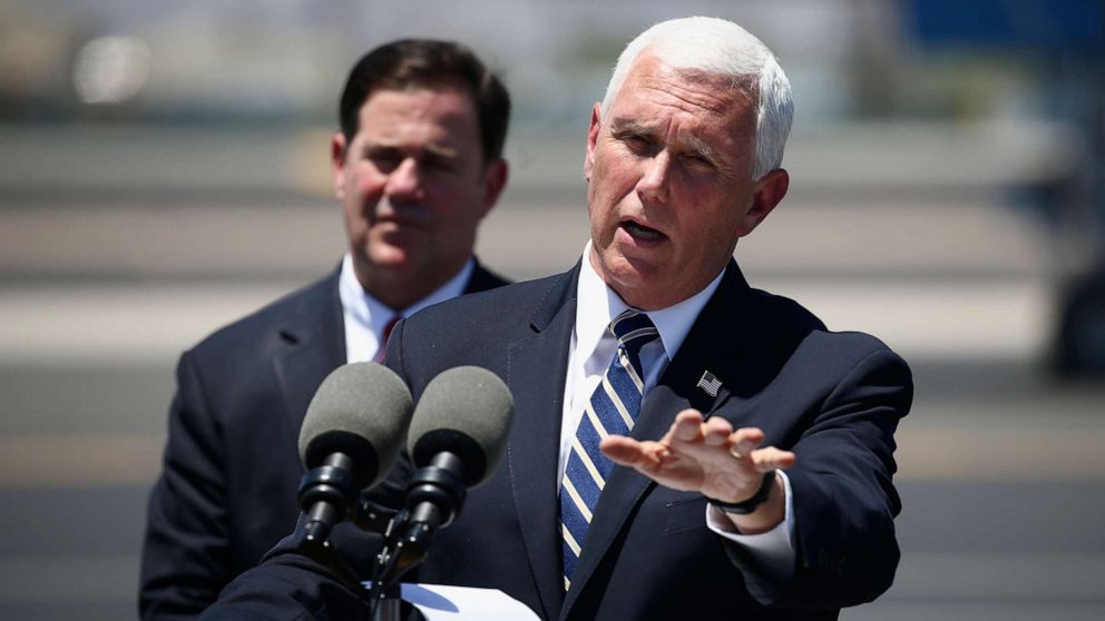 PHOTO: Vice President Mike Pence, right, answers a question as he holds a news conference with Arizona Gov. Doug Ducey, left, after their meeting to discuss the surge in coronavirus cases in Arizona Wednesday, July 1, 2020, in Phoenix.