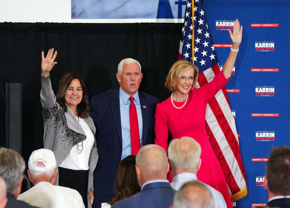 PHOTO: Former Vice President Mike Pence and his wife Karen Pence wave to the crowd with gubernatorial candidate Karrin Taylor Robson during her campaign event at TYR Tactical on July 22, 2022, in Peoria, Arizona.