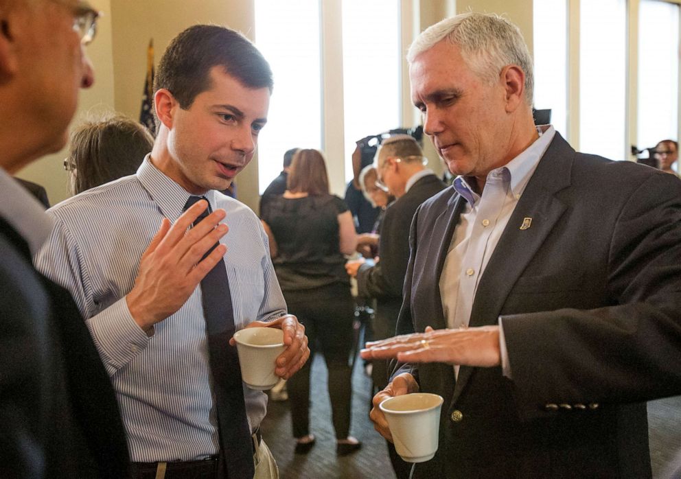 PHOTO: In this May 1, 2015, file photo, then-Indiana Gov. Mike Pence, right, talks with South Bend Mayor Pete Buttigieg during a visit to recap the legislative session that ends in South Bend.