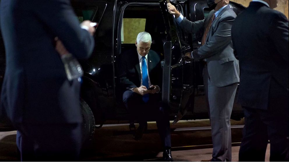 PHOTO: A photo taken by a White House photographer on Jan. 6, 2021 shows Vice President Mike Pence looking at a tweet by President Donald Trump on his phone in an underground parking garage of the U.S. Capitol complex during the insurrection.
