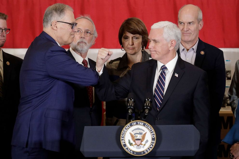 PHOTO: Vice President Mike Pence bumps elbows with Washington Gov. Jay Inslee, left, during a news conference, March 5, 2020, at Camp Murray in Washington state.