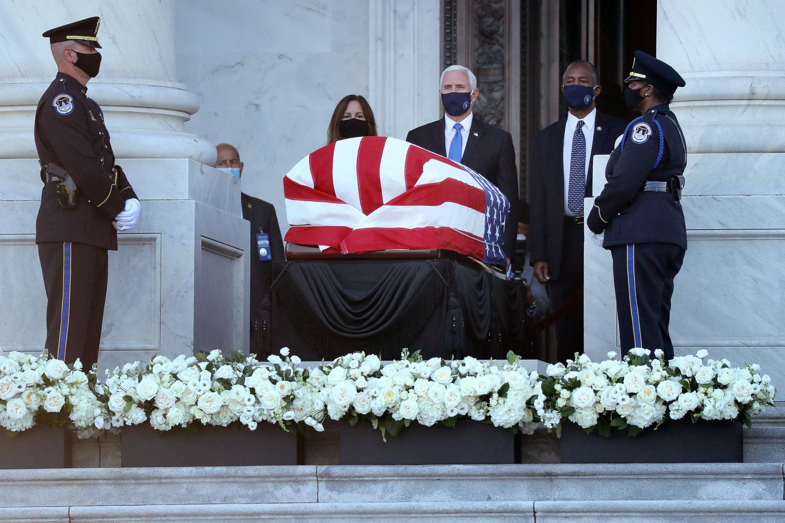 PHOTO: Vice President Mike Pence, his wife Karen Pence and Housing and Urban Development Secretary Ben Carson pay their respects to Rep. John Lewis (D-GA) as his flag-draped casket is displayed at the Capitol, July 27, 2020, in Washington, D.C. 