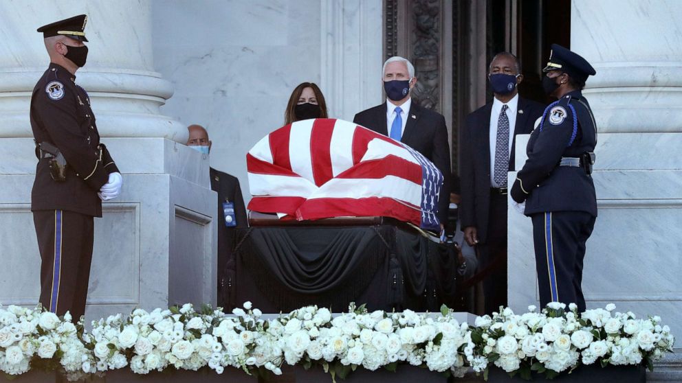 PHOTO: Vice President Mike Pence, his wife Karen Pence and Housing and Urban Development Secretary Ben Carson pay their respects to Rep. John Lewis (D-GA) as his flag-draped casket is displayed at the Capitol, July 27, 2020, in Washington, D.C.