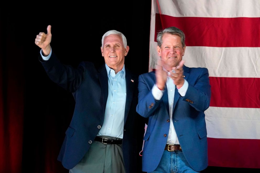 PHOTO: Former Vice President Mike Pence, left, and Georgia Gov. Brian Kemp, right, greet the crowd during a Get Out the Vote Rally, May 23, 2022, in Kennesaw, Ga.