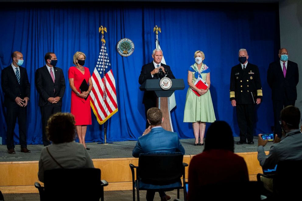 PHOTO: Vice President Mike Pence, center, takes off his face mask at the start of a White House Coronavirus Task Force briefing at the Department of Education building Wednesday, July 8, 2020, in Washington.