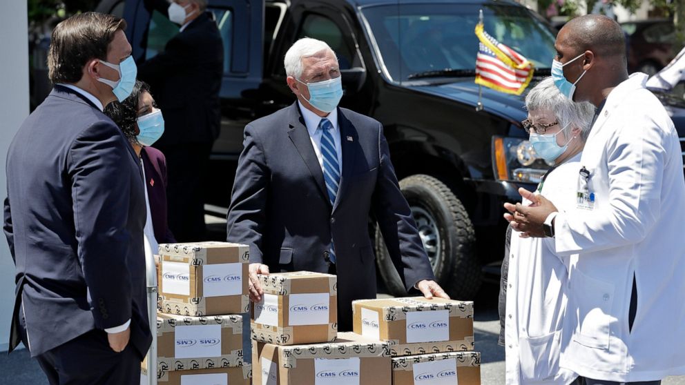 PHOTO: Vice President Mike Pence, center, speaks to staff members after delivering personal protective equipment to the Westminster Baldwin Park, Wednesday, May 20, 2020, in Orlando, Fla., as part of the initiative to deliver PPE to nursing homes. 